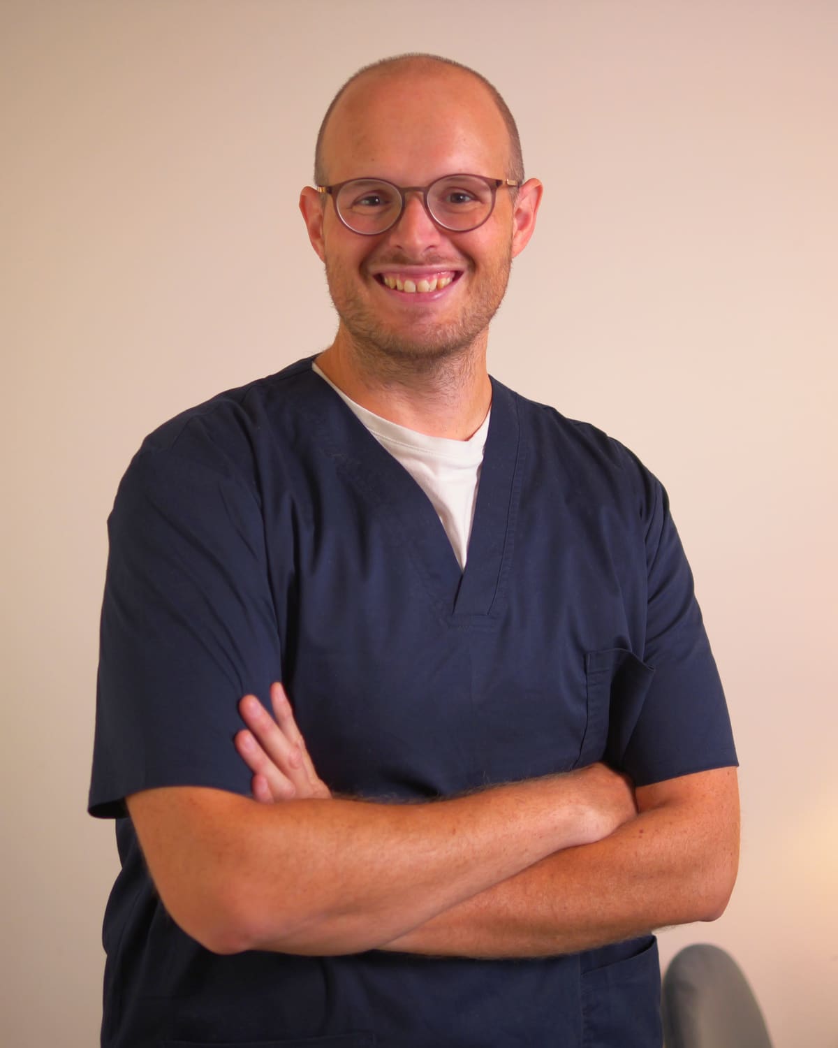 Federico in divisa blu scura, sorridente, a braccia conserte nello studio